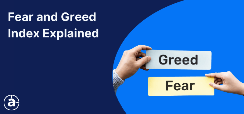 Two hands holding cards saying "Fear" and "Greed". White text in the background reads "Fear and Greed Index Explained".