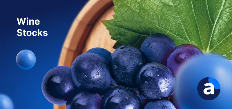 A bunch of grapes on a blue background with text reading Wine Stocks.